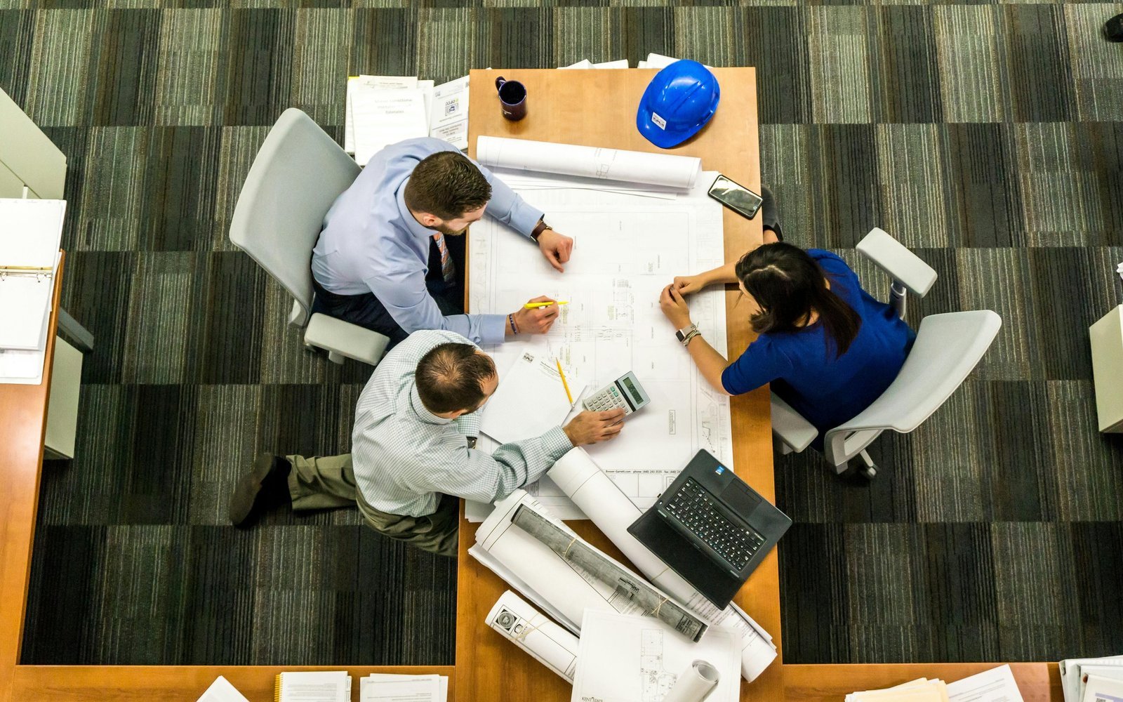 Aerial view of consulting team reviewing plans